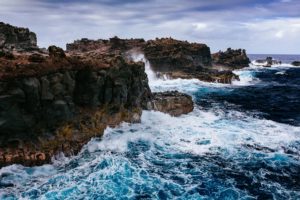 Ocean waves hitting hard on the rock cliffs