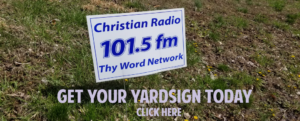 A white colored yard sign of christian radio