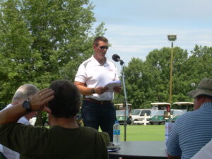 A man in white tshirt making an announcement