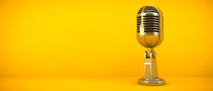 gold microphone on yellow background