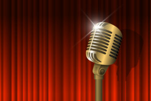 Gold vintage microphone and red curtain background